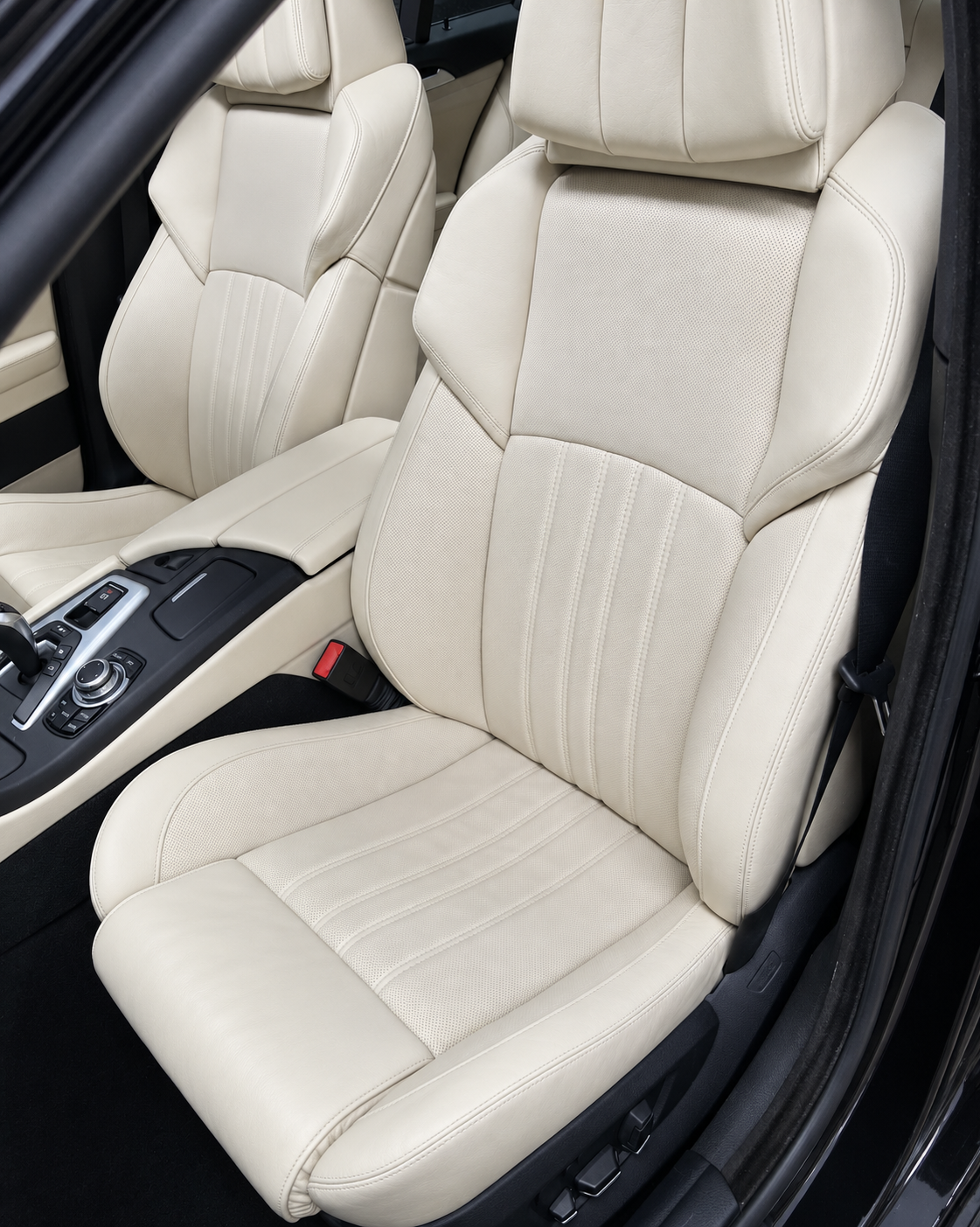 Ivory leather car seats with perforated panels and matching trim