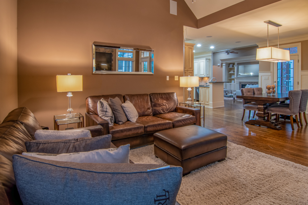 Spacious living room with modern furniture and warm lighting for a cozy atmosphere.